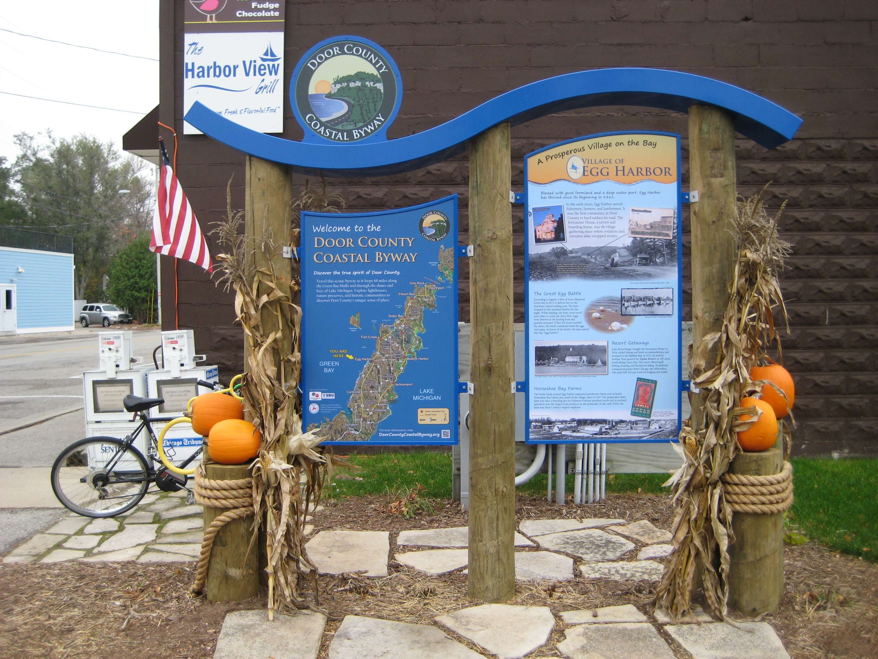 A custom StoryWalk structure with a decorative shaped header on timber posts